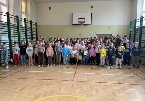 Uczniowie klas I-VIII wraz z pracownikiem schroniska p. Justyną oraz podopiecznym schroniska pieskiem Rino